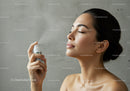 Young Woman Using Facial Mist for Skin Hydration and Refreshment