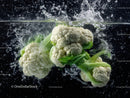 Fresh Cauliflower Head Surrounded by Water Splash in Dynamic Shot
