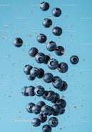 Fresh blueberries suspended in clear water splash