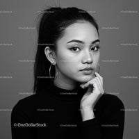 Elegant Black and White Portrait of Young Woman with Hoop Earrings