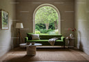 Cozy living room with green sofa and garden view