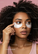 Young Woman with Curly Hair Applying Facial Mask for Skincare
