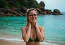 Happy Woman in Green Bikini on Tropical Beach with Cliffs