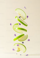 Floating green apple slices with delicate purple flowers