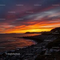 Dramatic Sunset over Rocky Coastline with Vibrant Sky