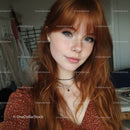 Fresh Redheaded Woman with Freckles and Green Eyes in Casual Setting