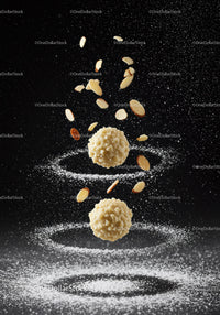 Almond coated truffles with powdered sugar swirls