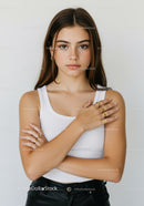 Young Woman Wearing White Tank Top and Black Pants with Jewelry