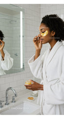 Woman Applying Facial Mask in Modern Bathroom for Skin Care and Relaxation
