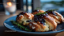 Fresh Croissants with Blueberry Jam and Rosemary Garnish