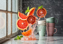 Fresh citrus slices splashing with ice and mint leaves