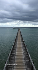 Wooden Pier Leading to Lighthouse Under Dramatic Cloudy Sky
