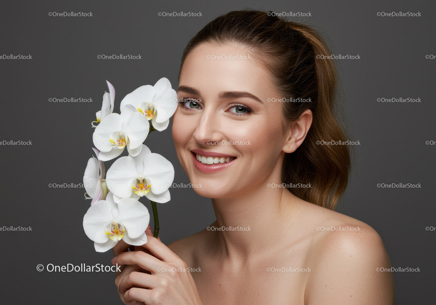 Portrait of a Smiling Woman with White Orchid Flowers on Grey Background