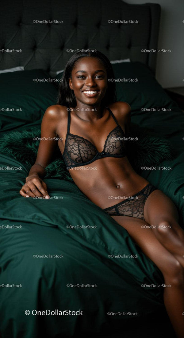 Smiling woman relaxing in black lace lingerie on bed
