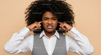 Frustrated Women Covering Ears Expressing Displeasure