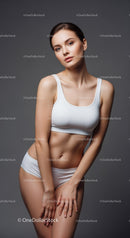 Elegant Young Woman with Toned Abs in White Sports Bra