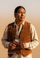 Native American Man in Leather Vest and Beaded Necklaces in Desert Landscape