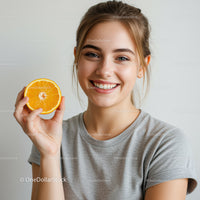 Bright Smiling Woman Holding Orange Half in Natural Light