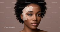 Beautiful Black Woman with Curly Hair and Healing Bandage on Face
