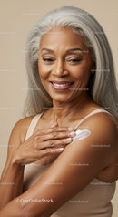 Elegant Elderly Woman with Gray Hair Applying Skincare Creme