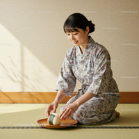 Japanese woman in kimono arranging rice balls on plate