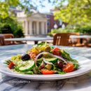 Colorful Fresh Vegetable Salad with Tomatoes and Olives in Bright Outdoors