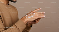 Close-up of a Man Applying Moisturizer to Hands for Skin Care