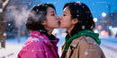 Couple sharing a tender kiss in snowy winter evening