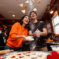 Happy couple baking heart-shaped cookies for Valentine