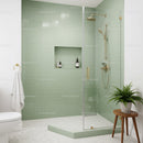 Modern bathroom with green tiled shower and plants
