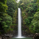 Tall Waterfall Cascading Through Dense Tropical Forest Landscape