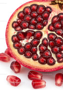 Close up of ripe pomegranate seeds and fruit half