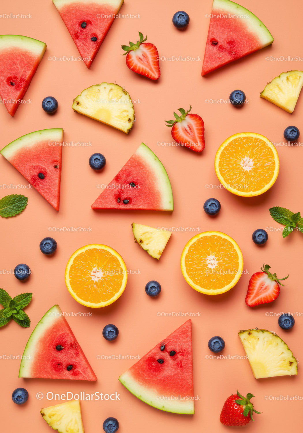 Fresh summer fruits slices arranged on peach background