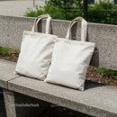 Two Plain Canvas Tote Bags on Concrete Bench Outdoors
