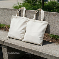 Two Plain Canvas Tote Bags on Concrete Bench Outdoors