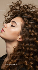 Close-up of calm woman with flowing curly hair