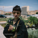 Fashionable Woman with Short Dark Hair and Green Smoothie on Rooftop
