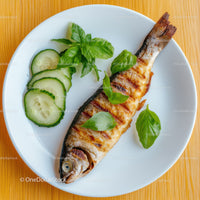 Grilled Fish with Cucumber and Basil on White Plate