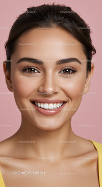 Smiling young woman with natural makeup on pink background