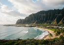 Tropical Beach with Mountain Cliffs and Lush Green Hills