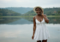 Beautiful Woman in White Dress with Wide-Brim Hat by Lake