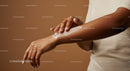Woman Applying Lotion to Arm for Moisturizing Skin with Soft Texture