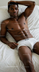 Young man relaxing in white underwear on bed