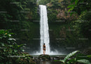 Lush Jungle Waterfall with Woman Standing on Rocks