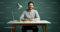 Smiling Young Man at a Modern Desk with Green Accents