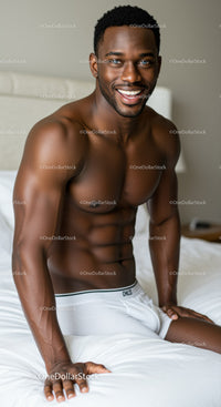 Fit man with bright smile relaxing on bed in underwear