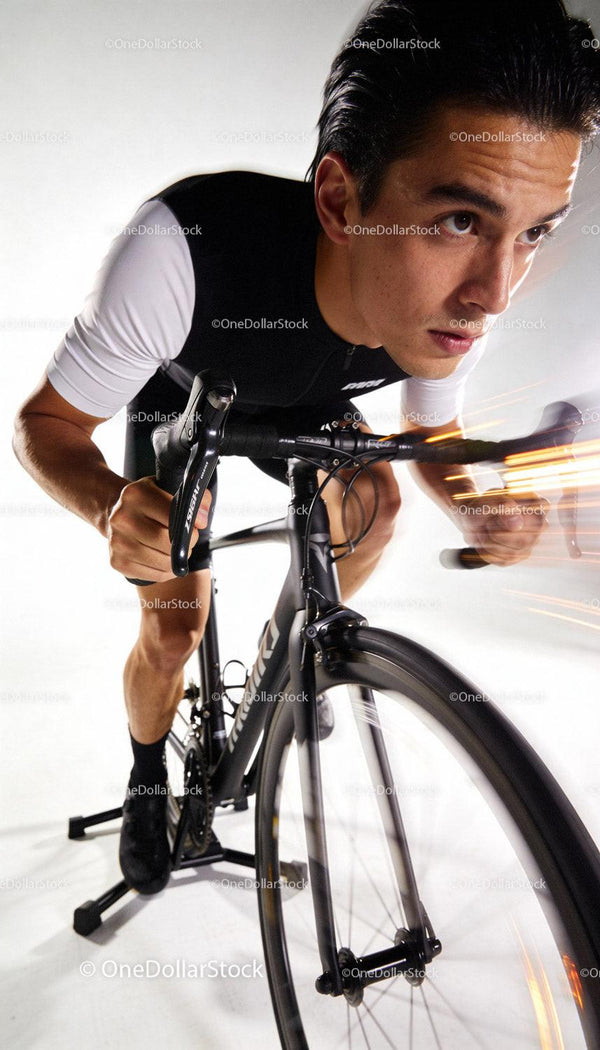 Focused cyclist training intensely on stationary bike