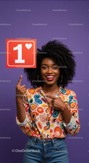 Joyful Woman Pointing at Heart Sign with Bright Smile