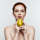 Elegant Woman Holding Green Pear with Pink Lips and Red Hair