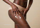 Close-Up of Woman's Legs Applying Skin Moisturizer with Skincare Products